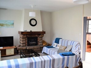 TV, fireplace - Charming House with Garden, Courtyard & WIFI in Perros-Guirec Near Port of Ploumanac'h (Perros-Guirec)