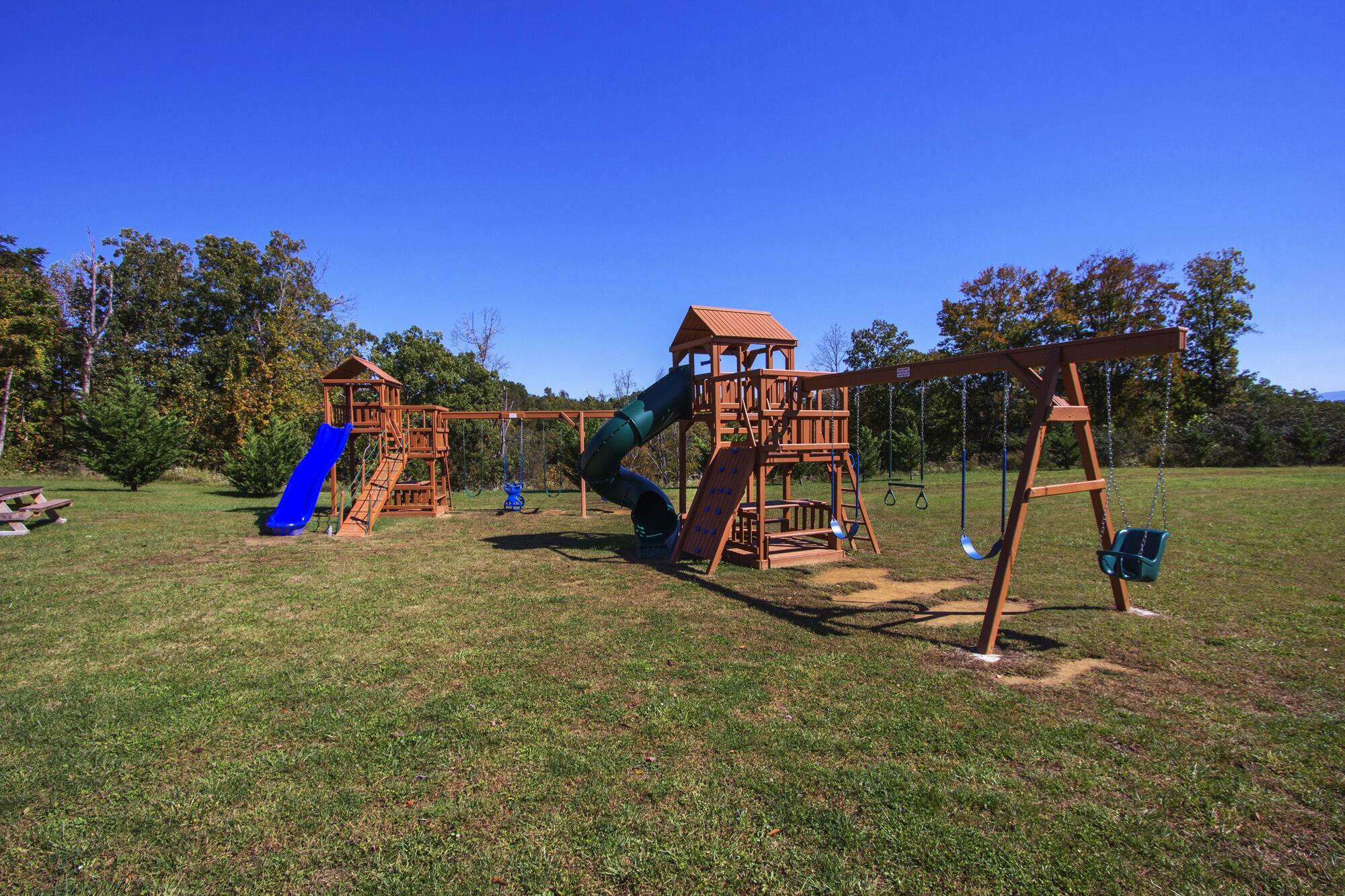 A playground with a slide, swings, and a climbing structure.