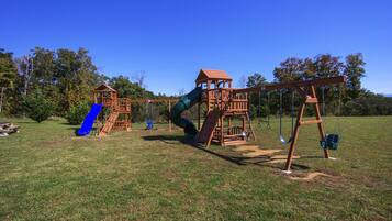 A playground with a slide, swings, and a climbing structure.