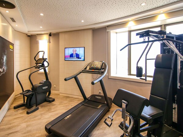 A gym with treadmills, a stationary bike, and a weight machine.