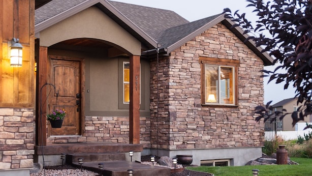A house with a stone facade, a wooden door, and a well-lit entrance. - Within Minutes Of BYU, Temples, Skiing  Sleeps 18 (Vineyard)
