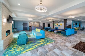 A spacious lobby with a fireplace, multiple seating areas, and a reception desk. - Comfort Inn & Suites Oklahoma City near Bricktown (Oklahoma City)