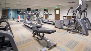 A gym with treadmills, elliptical machines, and a bench press. - Holiday Inn Express Suites Tulsa East Catoosa IHG (Tulsa)