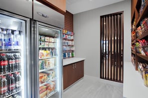 A kitchenette with a refrigerator stocked with beverages, a microwave, and a coffee machine. - Holiday Inn Express & Suites Lubbock Central - Univ Area by IHG (Lubbock)