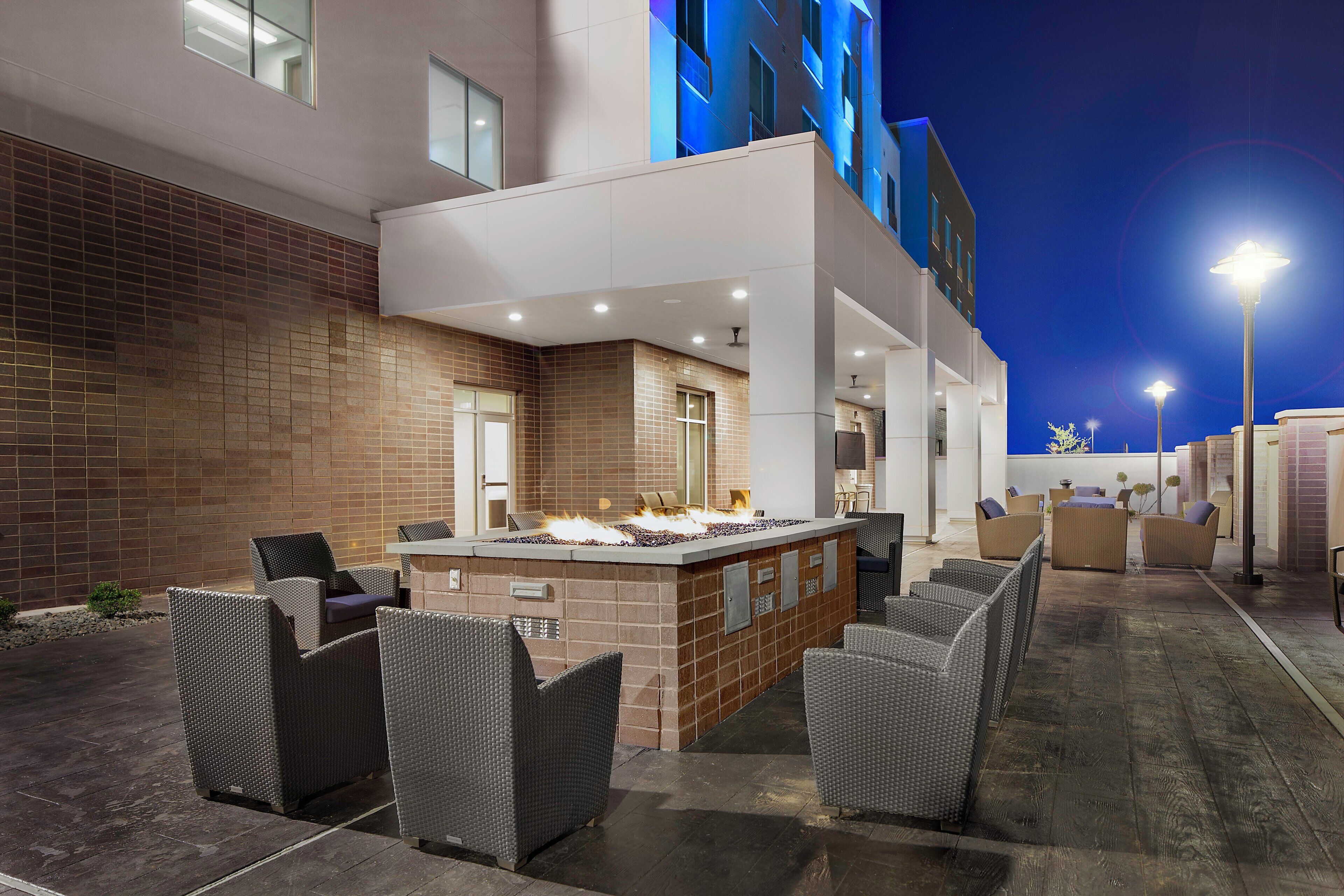 An outdoor bar area with seating and a fire feature.