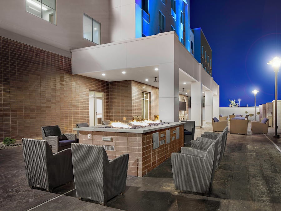 An outdoor bar area with seating and a fire feature.