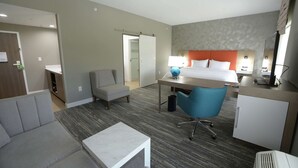 A hotel room with a bed, desk, chair, and a small sofa. - Hampton Inn & Suites Oklahoma City/Quail Springs (Oklahoma City)