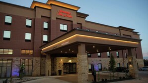 A Hampton Inn & Suites building with a brick facade, a covered entrance, and a sign indicating the name. - Hampton Inn & Suites Oklahoma City/Quail Springs (Oklahoma City)