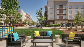 An outdoor seating area with a sofa, chairs, and a coffee table.