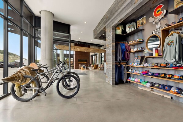 A modern retail space with bicycles, clothing, and accessories.