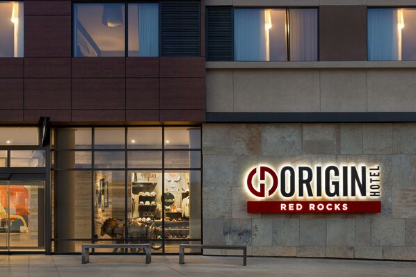 The exterior of the Origin Hotel Red Rocks with a clear view of the entrance and the hotel's name displayed on the facade.