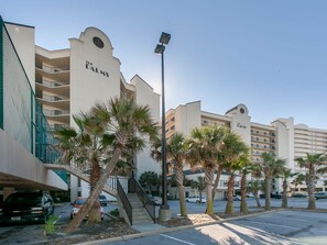 A hotel with multiple balconies, palm trees, and a clear sky. - Breathtaking Views, Views, Views! Oceanfront wraparound balcony; 3 BR and 3 BA. (Orange Beach)