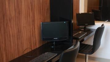 A modern office space with a Samsung monitor, a keyboard, and a chair.