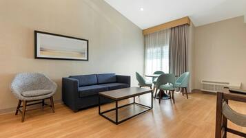 Suite, 1 King Bed, Balcony, River View | Living area | Flat-screen TV