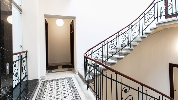 A modern interior with a marble staircase, a patterned rug, and a minimalist design. - Otium Jewish Quarter Miodowa (Kraków)