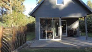 A small, single-story house with a sloped roof and a covered porch. - Beachfront - Österlen (Degeberga)