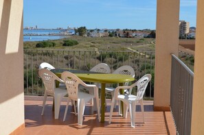 Outdoor dining - Penthouse apartment with roof terrace, communal pool, sea views (Los Nietos)