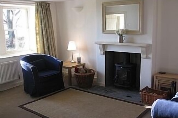 Sitting-room with woodburning stove and sea views