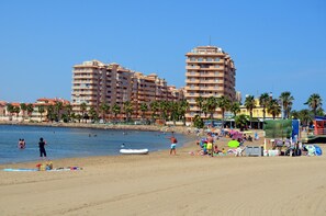 A beach with a row of multi-story buildings in the background. - Family apartment, 1st floor, sea views, communal pool, next to beach (La Manga del Mar Menor)