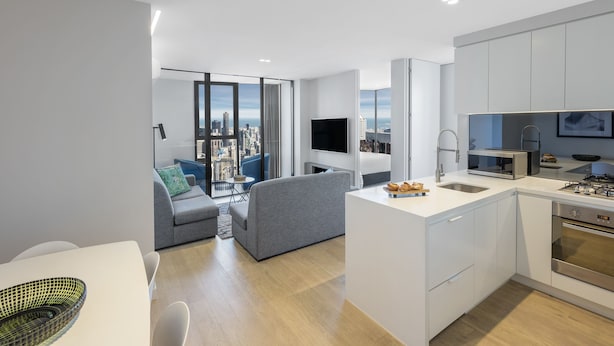 A modern apartment with a kitchen, dining area, and living space.