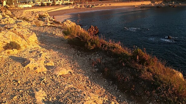 A coastal hotel with a rocky shoreline, a beach, and a building with multiple windows and balconies. - Magnificent Villa with private pool on large plot unlimited free wifi (L'ESCALA)