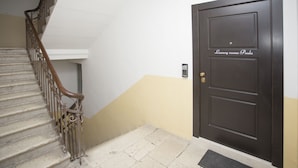A staircase with ornate metal railings leading to a dark wooden door with a sign reading "Luxury rooms Paula". - Luxury rooms Paula (Split)