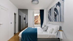 A modern bedroom with a bed, a bedside lamp, and a view of the outside. - Luxury rooms Paula (Split)