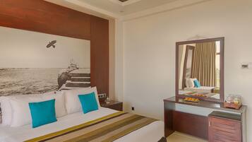 A hotel room with a large bed, a wooden headboard, a nightstand, a dresser, and a mirror.