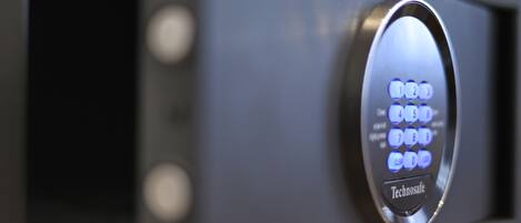A close-up of a keypad with illuminated buttons and the brand name "Technosafe" on a metallic surface.