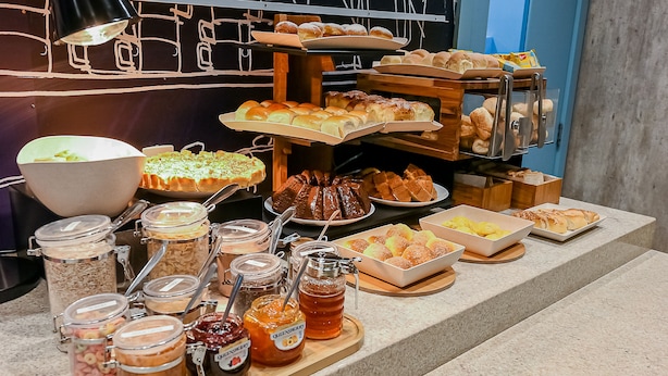 A buffet with various food items and condiments.