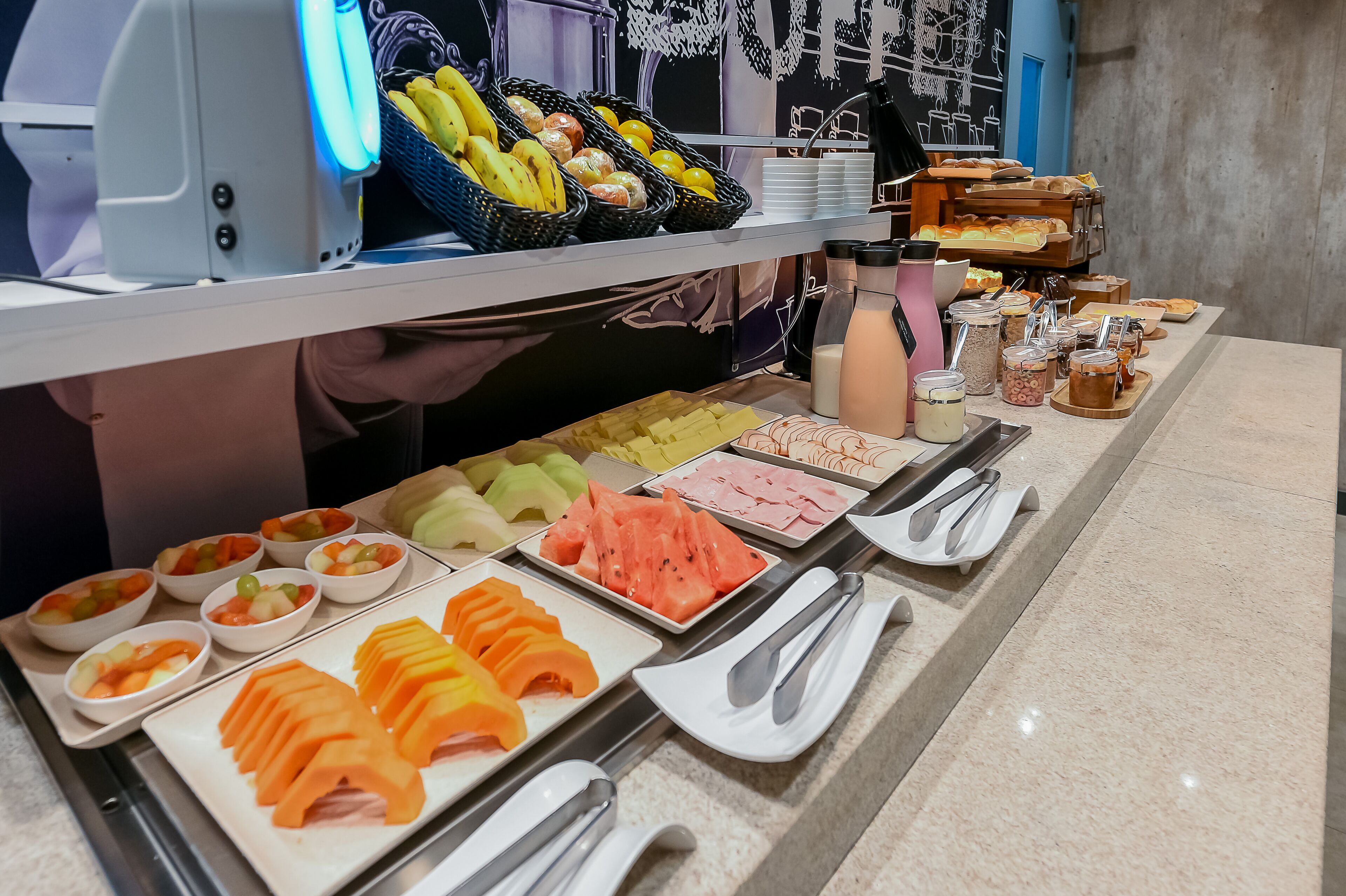 A buffet with various fruits, vegetables, and meats.