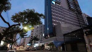 A multi-story hotel with a modern design, featuring a prominent 'HOTEL' sign on the facade.