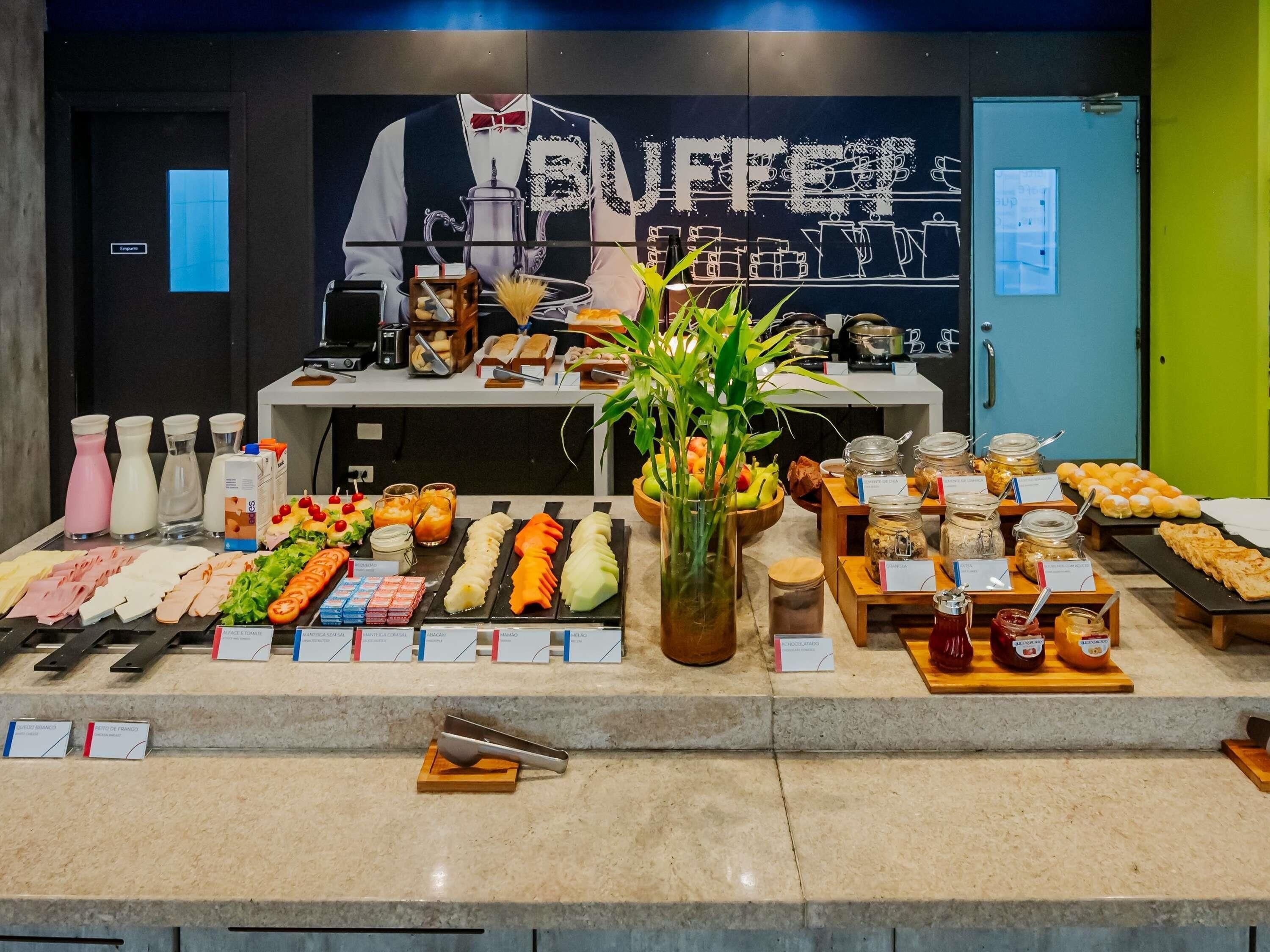 A buffet with various food items and condiments.