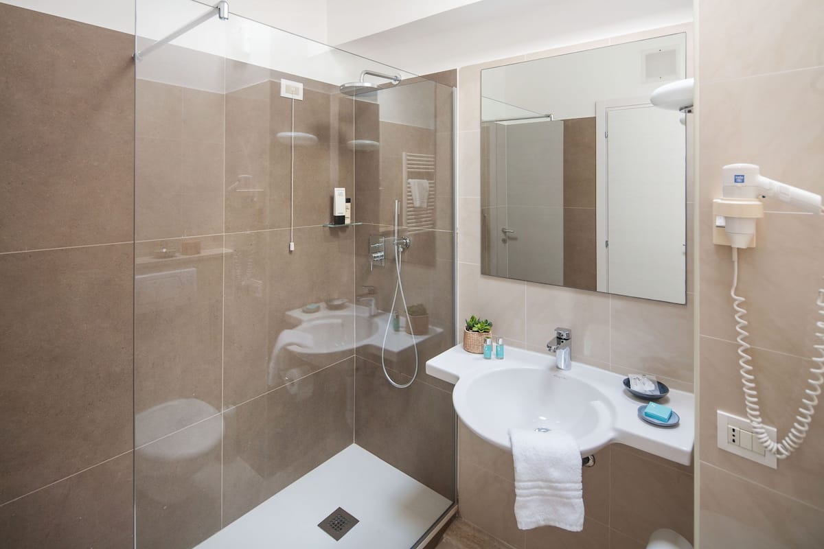 comfort room | bathroom | hair dryer, towels, soap, shampoo