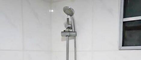 A shower with a handheld showerhead and a handheld faucet.