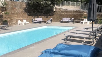 Seasonal outdoor pool, open 9:00 AM to 7:00 PM, pool umbrellas