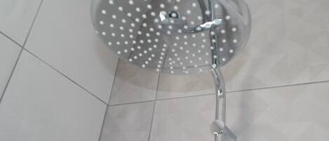 Una ducha con cabezal circular y múltiples rociadores.