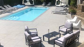 Seasonal outdoor pool, open 9:00 AM to 7:00 PM, pool umbrellas
