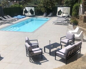 Seasonal outdoor pool, open 9:00 AM to 7:00 PM, pool umbrellas