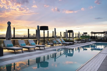 Relax by the rooftop pool with a stunning city view. at The Jacquard, Autograph Collection