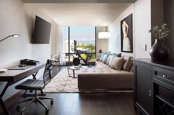 Enjoy a panoramic city view from the large window, relax on the comfortable sofa, and work at the sleek desk. at The Jacquard, Autograph Collection