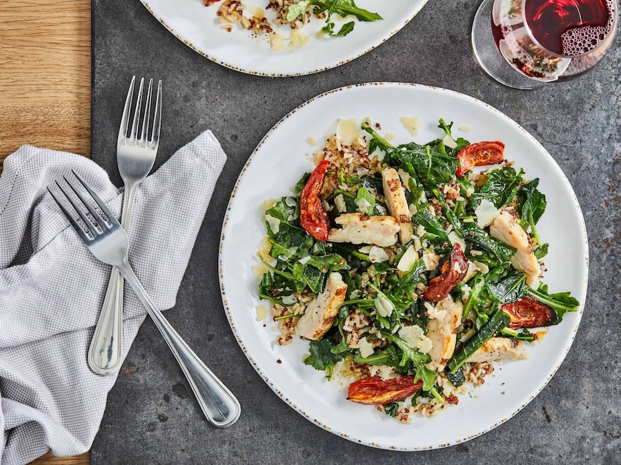 A plate of food with a fork and a napkin on a table.