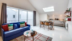 A modern apartment with a living room, dining area, and kitchenette. - Sweett | Brune IX - Two Bedroom Apartment, Sleeps 6 (Paris)