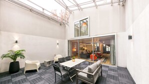A modern patio with a dining table, chairs, and a sofa. - Sweett | Brune I - Two Bedroom Apartment, Sleeps 6 (Paris)