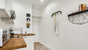 A modern kitchen with a wooden countertop, a built-in oven, and a stainless steel sink.
