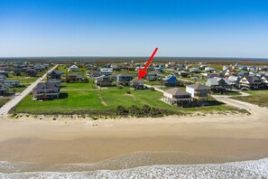 A coastal residential area with houses, a beach, and a pier. - Miller's Landing (Port Bolivar)
