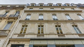 A multi-story building with classical architectural features, including ornate window frames and decorative moldings.