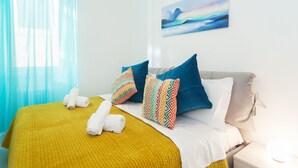 A hotel room with a bed, a nightstand, a painting on the wall, and a window with curtains. - Casa Bella Pantheon (Rome)