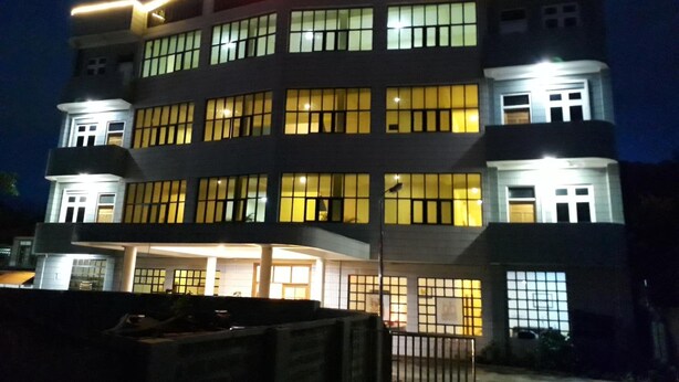 A multi-story hotel with illuminated signage and windows.