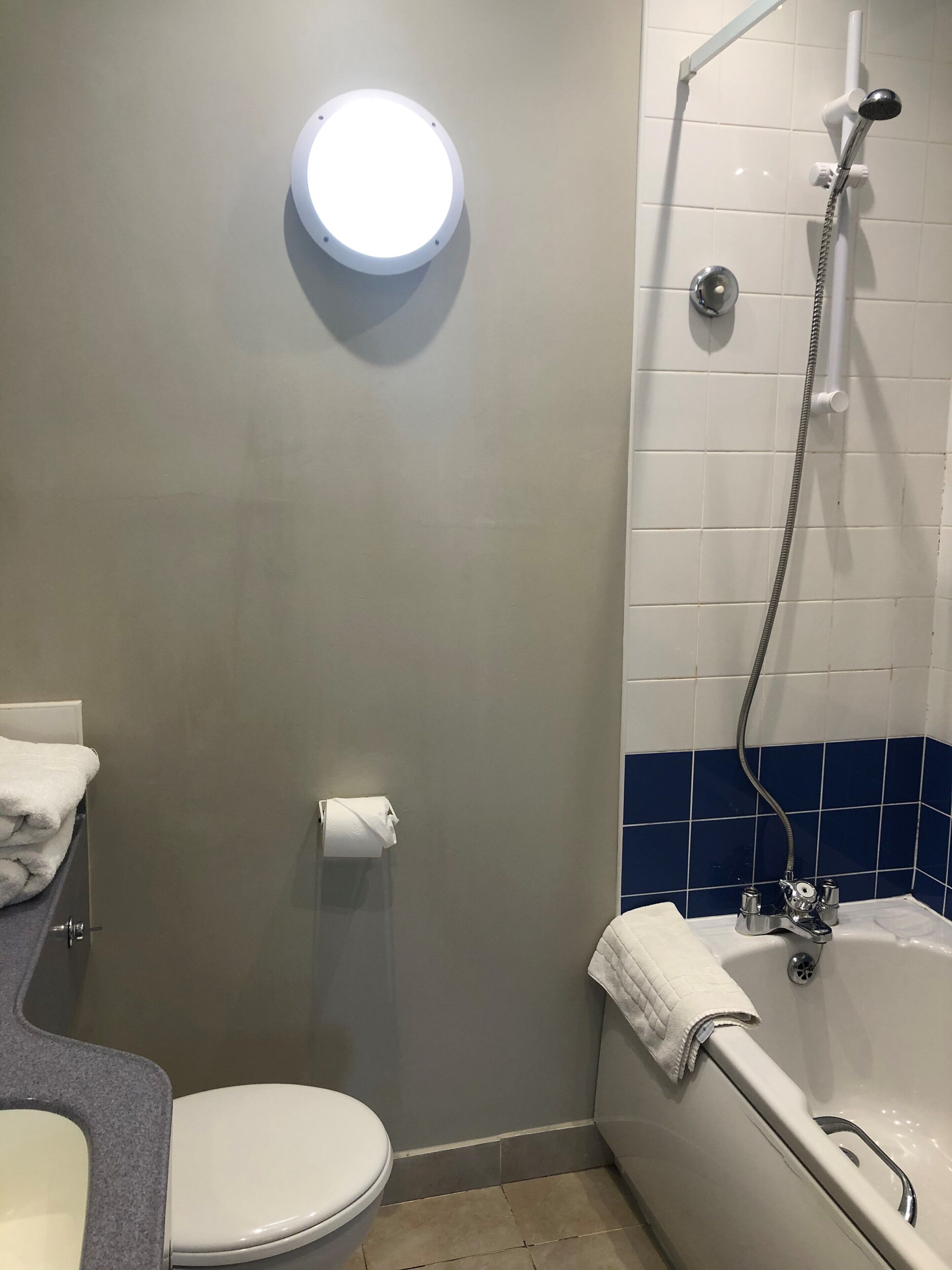 A bathroom with a toilet, a sink, a bathtub, and a shower.